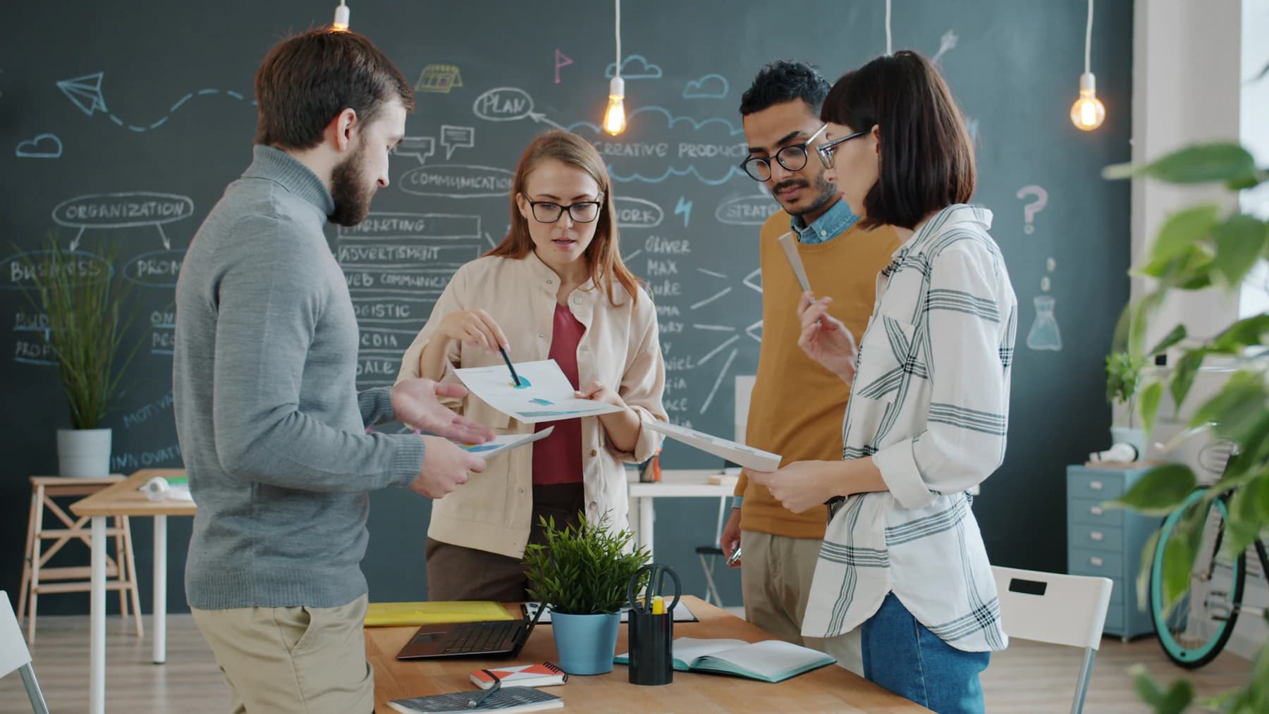 A creative team reviewing ideas together in a studio.