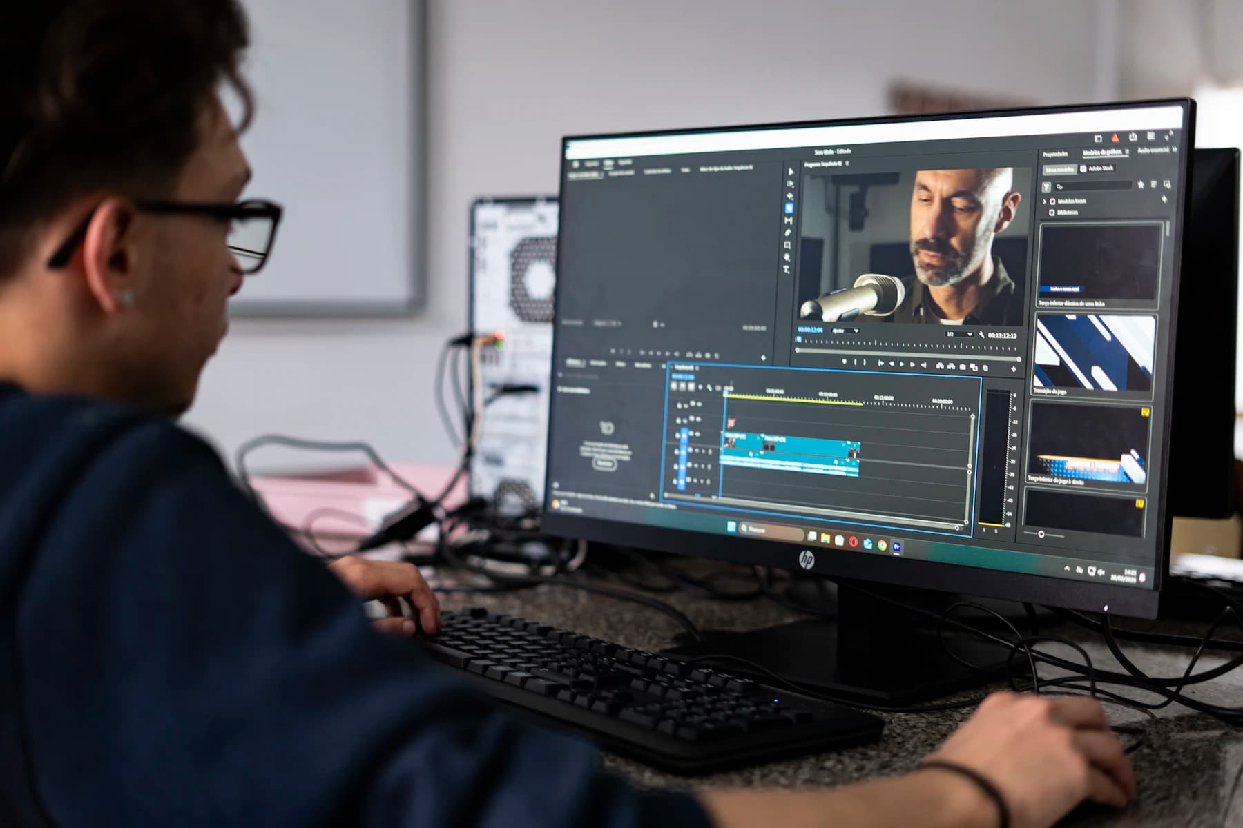 A video editor shaping an interview at a professional workstation.
